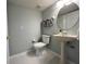 This bathroom features a toilet, pedestal sink, and decorative oval mirror at 2706 Camaro Dr, Kissimmee, FL 34746