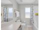 Bright bathroom showing a toilet and a shower with patterned curtains at 2706 Camaro Dr, Kissimmee, FL 34746