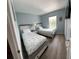 This bedroom features two twin beds, and wood flooring at 2706 Camaro Dr, Kissimmee, FL 34746