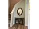 Inviting entryway featuring a decorative table, stools, mirror and staircase at 2706 Camaro Dr, Kissimmee, FL 34746