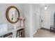 Inviting entryway featuring a decorative mirror, console table with flowers, and a view of the front door at 2706 Camaro Dr, Kissimmee, FL 34746