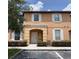 Charming two-story condo with tan exterior, white trim, and covered front porch at 2706 Camaro Dr, Kissimmee, FL 34746