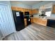Functional kitchen with light wood cabinets, black appliances, and modern flooring at 2706 Camaro Dr, Kissimmee, FL 34746