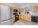 Bright kitchen showcasing wood cabinets, stainless steel appliances and modern flooring at 2706 Camaro Dr, Kissimmee, FL 34746