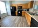Functional kitchen with light wood cabinets, black appliances, and modern flooring at 2706 Camaro Dr, Kissimmee, FL 34746