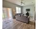 Cozy living room with comfortable seating, a ceiling fan, and access to outdoor patio at 2706 Camaro Dr, Kissimmee, FL 34746