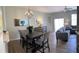 Open concept living space with dining area, comfortable seating, and a modern chandelier at 2706 Camaro Dr, Kissimmee, FL 34746