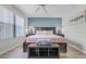 Bright main bedroom boasts wood floors, a ceiling fan, and an accent wall at 2706 Camaro Dr, Kissimmee, FL 34746