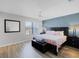 Comfortable main bedroom with wood floors, ceiling fan, and accent wall at 2706 Camaro Dr, Kissimmee, FL 34746