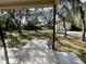View of the backyard from the patio; it features mature trees and a storage shed at 285 W 2Nd St, Chuluota, FL 32766