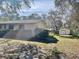 Side yard view of home and matching storage shed with room for activities at 285 W 2Nd St, Chuluota, FL 32766
