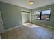 Bedroom features a window, tile floors, and a closet space at 285 W 2Nd St, Chuluota, FL 32766