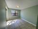 Vacant bedroom showcases tiled floors, a window, and natural light at 285 W 2Nd St, Chuluota, FL 32766