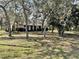 Single story home with mature landscaping and a sprawling front yard at 285 W 2Nd St, Chuluota, FL 32766