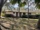 Inviting single story home featuring a brick accent wall and well-maintained landscaping at 285 W 2Nd St, Chuluota, FL 32766
