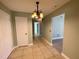 Hallway with tile flooring, a chandelier, and neutral paint, leading to the bedrooms at 285 W 2Nd St, Chuluota, FL 32766