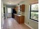 Traditional kitchen featuring wood cabinets, tile backsplash, and a stainless steel sink at 285 W 2Nd St, Chuluota, FL 32766
