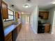 Kitchen with tile flooring, wooden cabinets, and black appliances at 285 W 2Nd St, Chuluota, FL 32766