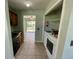 Utility area showing appliances, paint cans and a fire extinguisher at 285 W 2Nd St, Chuluota, FL 32766