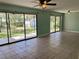 Open living area with sliding glass doors offering backyard views, enhanced by modern ceiling fans at 285 W 2Nd St, Chuluota, FL 32766