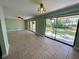 Bright living room boasts tile floors, ceiling fans, and sliding glass doors leading to the backyard at 285 W 2Nd St, Chuluota, FL 32766