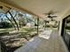 Covered patio with tile flooring and ceiling fans overlooking a spacious backyard at 285 W 2Nd St, Chuluota, FL 32766