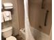 Hotel bathroom featuring a toilet, shower/tub combo, and towel rack, equipped for a comfortable stay at 3000 Maingate Ln # 210, Kissimmee, FL 34747