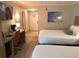 Hotel bedroom with two beds and a workspace, complete with a TV, offering a comfortable accommodation at 3000 Maingate Ln # 210, Kissimmee, FL 34747