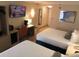 Hotel room featuring two beds, workspace, and a TV, offering a functional and cozy stay at 3000 Maingate Ln # 210, Kissimmee, FL 34747