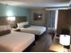 Comfortable hotel room with two beds, desk, and pleasant decor, creating a welcoming and relaxing space at 3000 Maingate Ln # 210, Kissimmee, FL 34747