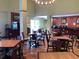 Bright hotel breakfast area with multiple tables and chairs, plus beverage and buffet station at 3000 Maingate Ln # 210, Kissimmee, FL 34747