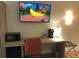 Desk area with TV, microwave, and coffeemaker, providing convenience and entertainment in a hotel room at 3000 Maingate Ln # 210, Kissimmee, FL 34747