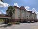 Exterior front view of Galleria Palms Hotel featuring attractive landscaping and well-maintained facade at 3000 Maingate Ln # 210, Kissimmee, FL 34747