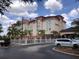 Exterior view of Galleria Palms Hotel showcasing its architectural style, palm trees and well-kept grounds at 3000 Maingate Ln # 210, Kissimmee, FL 34747