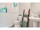 This bathroom features a ladder for towels, a pedestal sink, and artwork at 3061 Moulin Rd, Davenport, FL 33837