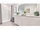 Bright bathroom with double vanity, large mirror, and walk-in shower at 3061 Moulin Rd, Davenport, FL 33837