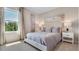 This bedroom features a large window with natural light and neutral decor at 3061 Moulin Rd, Davenport, FL 33837