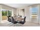 Modern dining area with sleek chairs, stylish table setting, and sliding glass doors to the yard at 3061 Moulin Rd, Davenport, FL 33837