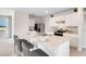 Bright, open kitchen features an island with bar seating, stainless steel appliances, and white cabinets and countertops at 3061 Moulin Rd, Davenport, FL 33837