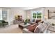 Cozy living room with neutral decor, comfortable seating, and abundant natural light, flowing to the open kitchen at 3061 Moulin Rd, Davenport, FL 33837