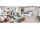 Open-concept living area with a spacious kitchen, island seating, comfortable couches and dining area at 3061 Moulin Rd, Davenport, FL 33837