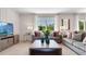 Comfortable living room featuring two sofas, neutral tones, and a large window at 3061 Moulin Rd, Davenport, FL 33837
