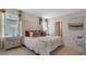 Inviting bedroom with a king bed, decorative pillows, bedside tables and a picture window at 3061 Moulin Rd, Davenport, FL 33837