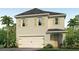 Charming two-story home with a two-car garage, landscaped yard and light tan stucco at 3065 Moulin Rd, Davenport, FL 33837