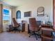 Bright office with two desks, brown leather chairs, and a window with a view at 3065 Moulin Rd, Davenport, FL 33837
