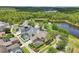 Aerial view showcasing the home's location with mature trees, backyard pool, and serene lake in the community at 3201 Glenmere Way, Orlando, FL 32828