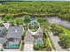 Stunning aerial view of waterfront home with screened-in pool and lush greenery at 3201 Glenmere Way, Orlando, FL 32828