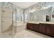 Bathroom with a glass shower, soaking tub, a large mirror, and double vanity with dark wood cabinets at 3201 Glenmere Way, Orlando, FL 32828