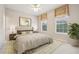 Well-lit bedroom with a tufted headboard, neutral color scheme, and two windows offering natural light at 3201 Glenmere Way, Orlando, FL 32828