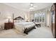 A bedroom with a decorative bed frame, bay window and a seating area for relaxation at 3201 Glenmere Way, Orlando, FL 32828